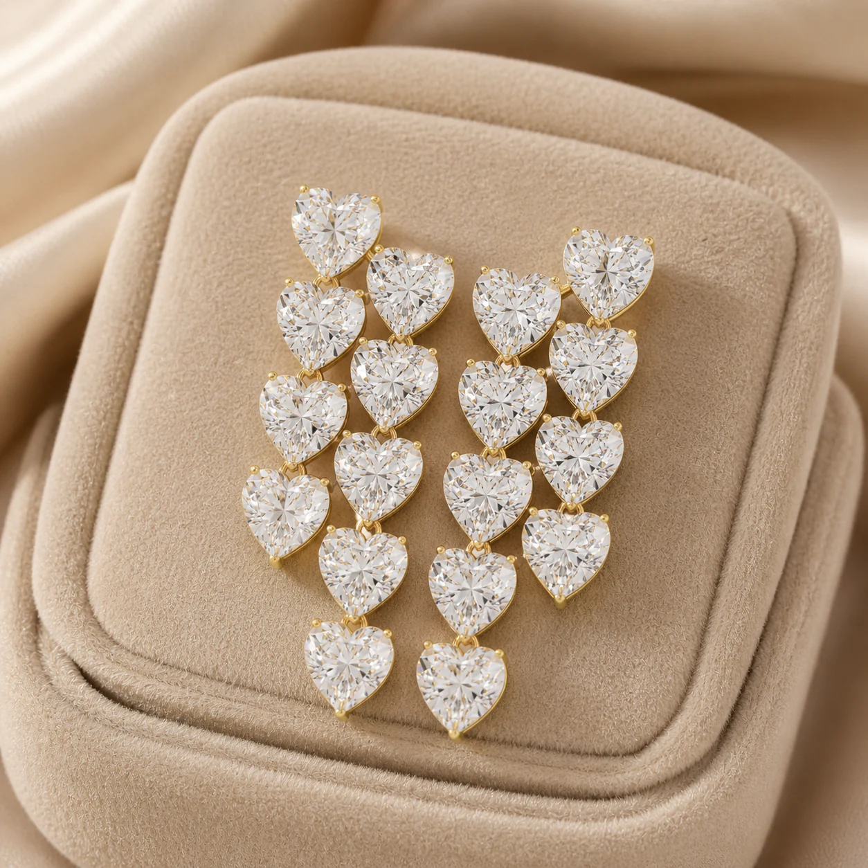 Heart-shaped diamond drop earrings arranged in a luminous cascade
