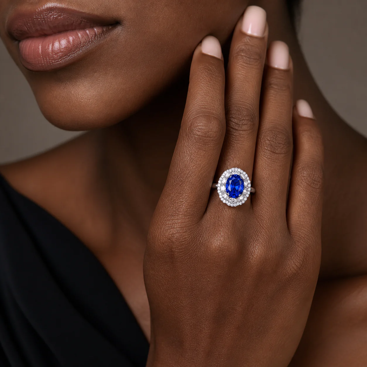 Blue oval ring with an intense centre stone set within a sculpted frame of light